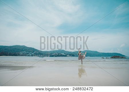 Handsome Girl On The Beach Background. Portrait Of A Woman In White Clothes On The Sea