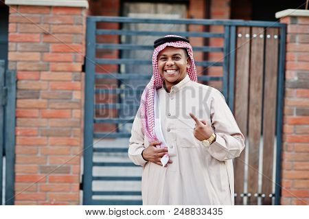 Middle Eastern Arab Man Posed On Street Against Modern Building And Showing Finger.