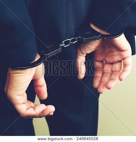 Arrested Businessman In Handcuffs. Businessman Bribetaker Or Briber, Toned Image. Concept Of Fraud, 