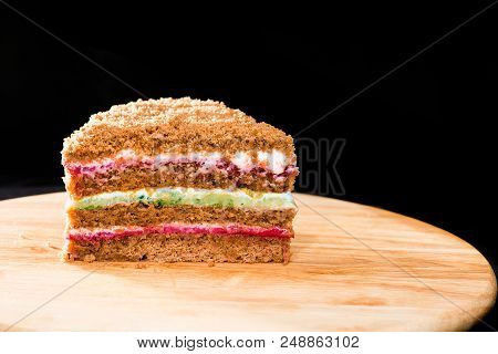 Close-up Of Sweet Homemade Layered Honey Cake On Round Wooden Board On Dark Background. Cake Made Wi