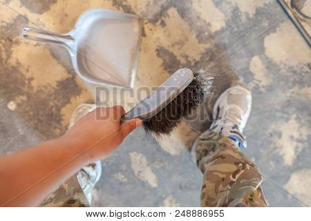 Hand Holds A Hand Broom On Construction Side