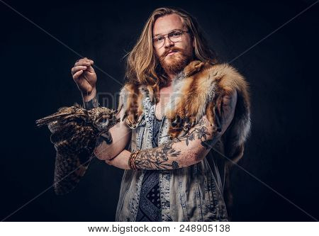 Portrait Of A Tattoed Redhead Hipster Male With Long Luxuriant Hair And Full Beard Dressed In A T-sh