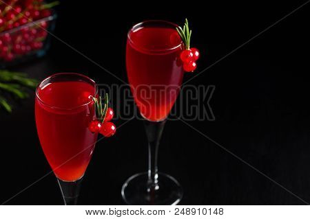 Two Glasses Of Redcurrant Wine Drink Juice Decorated With Rosemary And Berries, A Cup Of Redcurrant 