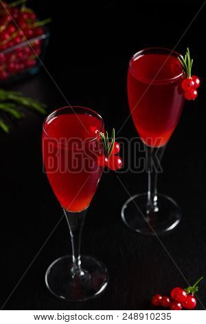 Two Glasses Of Redcurrant Wine Drink Juice Decorated With Rosemary And Berries, A Cup Of Redcurrant 