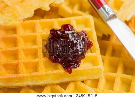 Close-up Of Brown Waffles With Homemade Marmelade.
View To Stacked Wafles With Jam.
Bakery And Food 