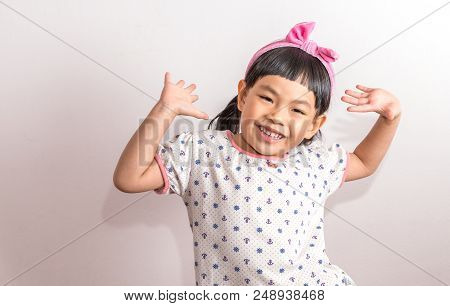 Portrait Of Child Acting Very Happy Or Asian Thai Little Girl Acting Very Happy With Hands Up And Bi