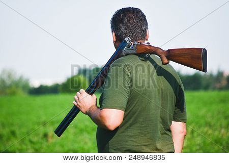 Hunter With Double Barrel Gun And In The Autum Field. Close Up.