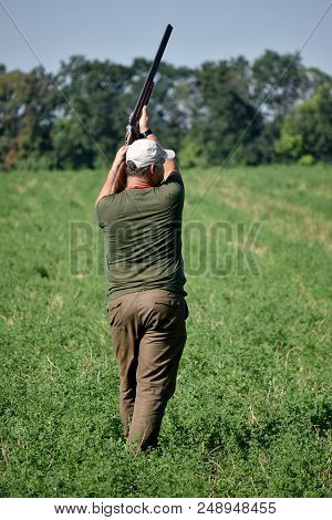 Hunter Shoot With Double Barrel Gun. Summer Time.