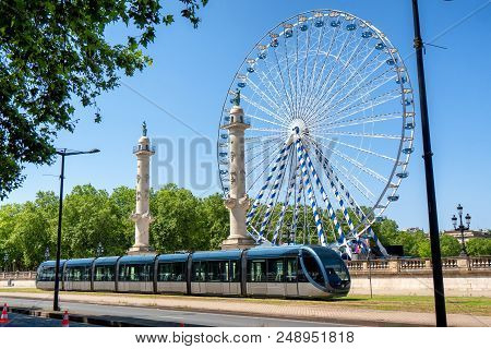 The Ferris Wheel In The City Of Bordeaux In France With Streetcar