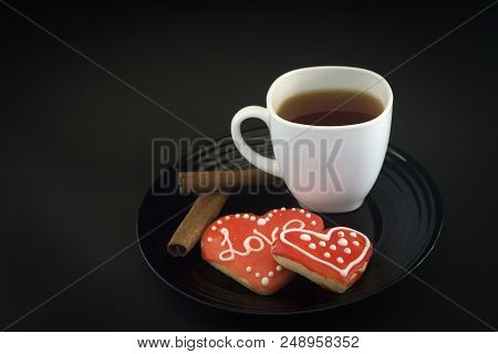 Cake On A Black Plate And Coffee In A White Cup.