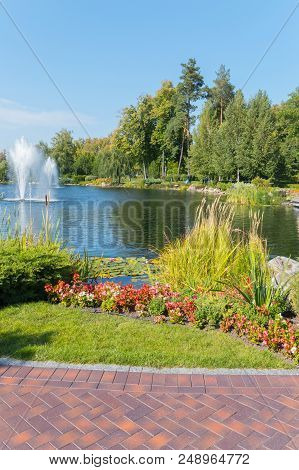 A Beautiful Lake With A Fountain And A Well-stocked Shore In A Picturesque Park. Mezhyhirya Ukraine