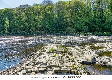 A View Of The River Lune Near Lancaster, With A Stone Jetty.
