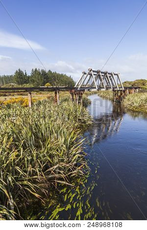 Old Railway Bridge Over Mahinapua Creek, Near Hokitka In The Wst Coast Region Of New Zealand.