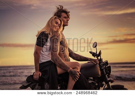Happy Girlfriend Leaning On Boyfriend Shoulder On Motorcycle On Ocean Beach