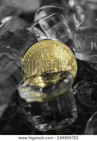 Gold Bitcoin On Ice Background. The Concept Of The Exchange In Winter. Freeze. Blockchain Mining. Di