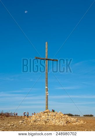 Pilgrims Pass By A Huge Wooden Cross On The Way - Alto Cruceiro, Castile And León, Spain