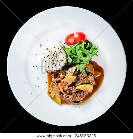 Delicious Beef With Oyster Mushrooms And Rice Served With Tomatoes And Sauce In A White Plate Isolat
