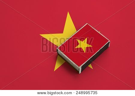 Vietnam Flag  Is Pictured On A Matchbox That Lies On A Large Flag.