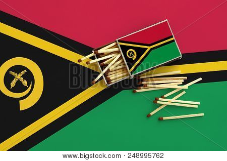 Vanuatu Flag  Is Shown On An Open Matchbox, From Which Several Matches Fall And Lies On A Large Flag
