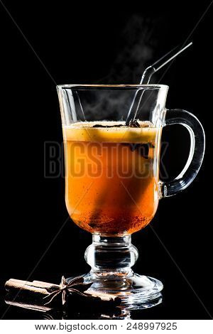 Hot Buttered Becherovka Cocktail With Honey, Cinnamon And Anise With Steam Isolated On Black Backgro