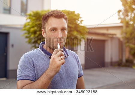 Electronic Cigarettes, Cigarette Technology. Tobacco Iqos System. Close-up Of A Man Smoking An Elect