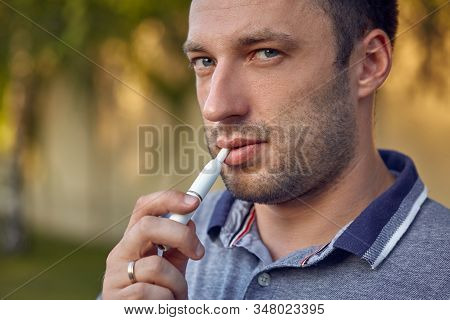 Electronic Cigarettes, Cigarette Technology. Tobacco Iqos System. Close-up Of A Man Smoking An Elect