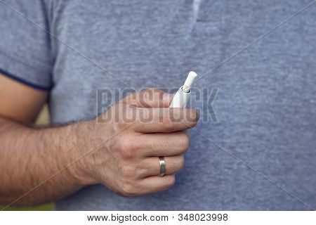 Electronic Cigarettes, Cigarette Technology. Tobacco Iqos System. Close-up Of A Man Smoking An Elect