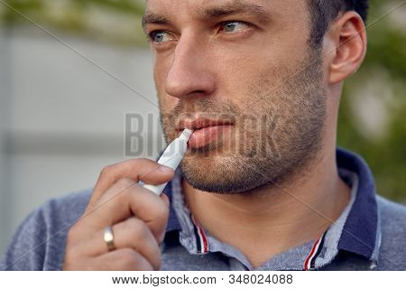 Electronic Cigarettes, Cigarette Technology. Tobacco Iqos System. Close-up Of A Man Smoking An Elect