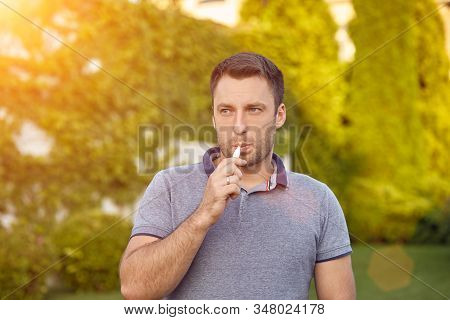 Electronic Cigarettes, Cigarette Technology. Tobacco Iqos System. Close-up Of A Man Smoking An Elect