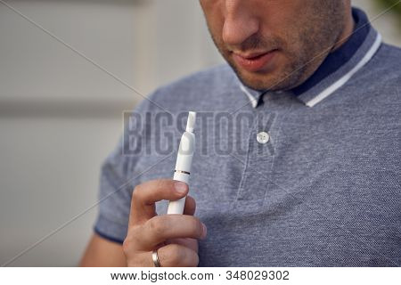 Electronic Cigarettes, Cigarette Technology. Tobacco Iqos System. Close-up Of A Man Smoking An Elect