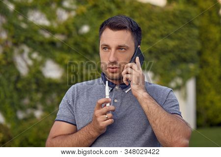 Electronic Cigarettes, Cigarette Technology. Tobacco Iqos System. Close-up Of A Man Smoking An Elect