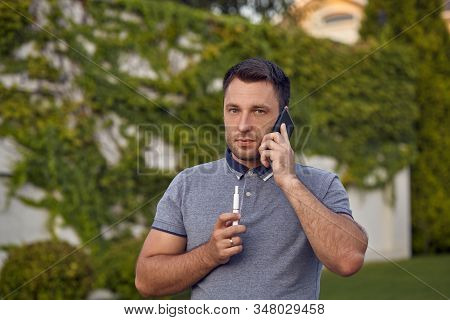 Electronic Cigarettes, Cigarette Technology. Tobacco Iqos System. Close-up Of A Man Smoking An Elect