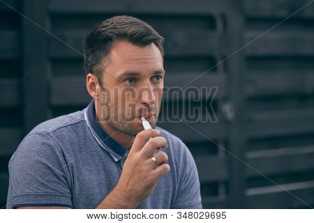 Electronic Cigarettes, Cigarette Technology. Tobacco Iqos System. Close-up Of A Man Smoking An Elect