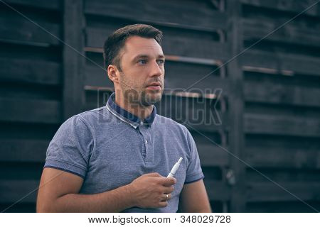 Electronic Cigarettes, Cigarette Technology. Tobacco Iqos System. Close-up Of A Man Smoking An Elect
