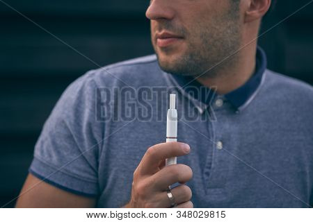 Electronic Cigarettes, Cigarette Technology. Tobacco Iqos System. Close-up Of A Man Smoking An Elect