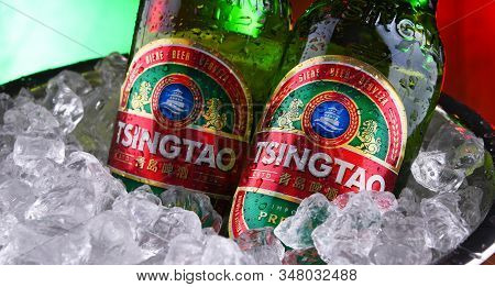 Two Bottles Of Tsingtao Beer In Bucket With Crushed Ice