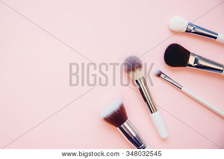 Set Makeup Brushes On Pink Color Background. Top View Point, Flat Lay