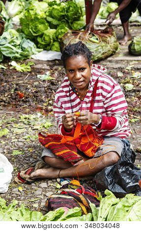 Indonesia, Papua New Guinea, Wamena, Irian Jaya, 20 August 2019: Papuan Woman Crochets A Multi-color