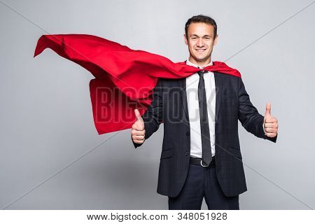 Young Handsome Businessman In Suit And Hero Cout With Thumbs Up On White Background