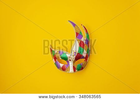 Festive, Colorful Mardi Gras Or Carnivale Mask And Accessories Over Yellow Background. Party Invitat