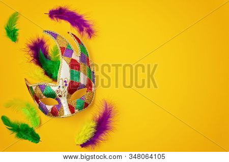 Festive, Colorful Mardi Gras Or Carnivale Mask And Accessories Over Yellow Background. Party Invitat