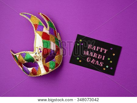 Festive, Colorful Mardi Gras Or Carnivale Mask And Greeting Card Over Purple Background. Party Invit