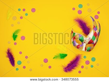 Festive, Colorful Mardi Gras Or Carnivale Mask And Accessories Over Yellow Background. Party Invitat