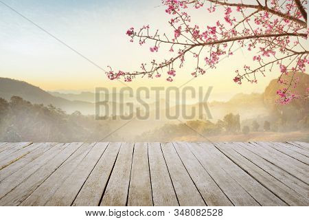 Empty Top Wooden Table And Sakura Flower With Fog And Morning Light  Background.