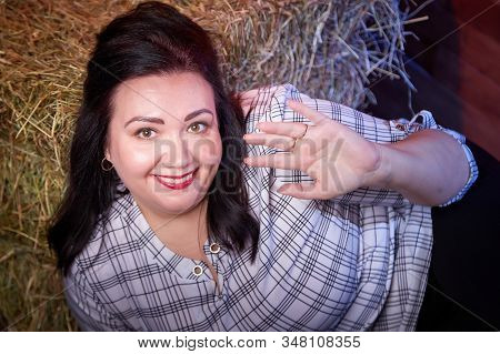 Portrait Of Fat Plump Fun Charming Cute Woman With Black Hair In The Room With Hay And Straw