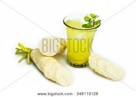 Close Up Shot Of Fresh Daikon Juice In A Glass Isolated On A White Background Along With Some Sliced