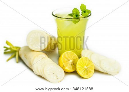 Close Up Shot Of Fresh Daikon Juice In A Glass Isolated On A White Background Along With Some Sliced