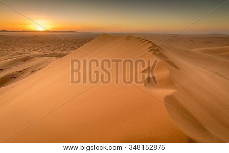 Sunset Over The Golden Orange Sand Dunes Of Sahara, Merzouga, Morocco