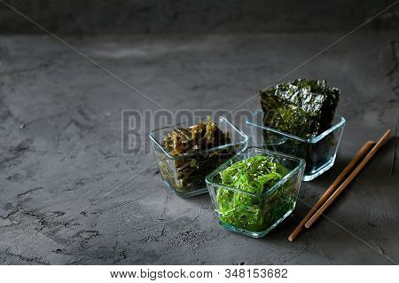 Traditional Japanese Snack - Chuka Wakame Seaweed Salad And Crispy Roasted Nori Sheets In Wooden Bow