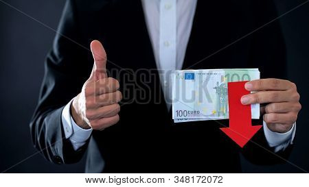 Financial Expert Holding Euro Banknotes, Showing Thumbs Up And Down, Falling